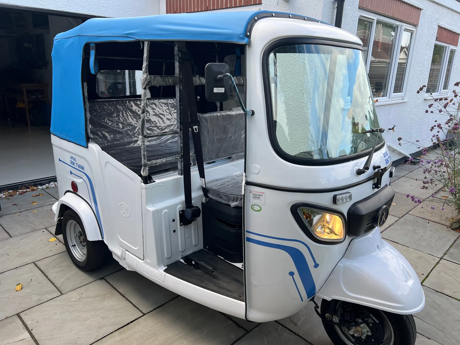 White and blue Atul Rik Twin demonstrator tuk tuk